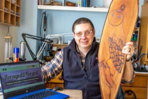 Simon Hobbs from Swanage with the laptop that was gifted to him by the Digital Doorway scheme and one of the crafts he has made.