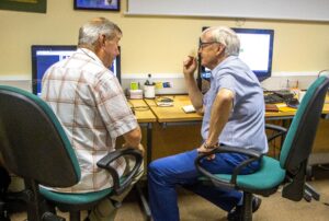 Learner Roger (left) speaking to volunteer digital champion David