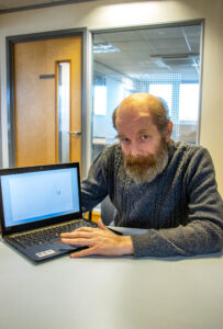 A man in Weymouth Job Centre with his new laptop