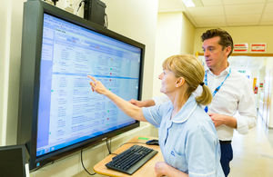 Nurse looks at health and care record