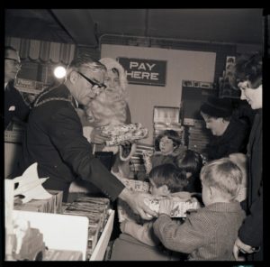 Santa hands out gifts to the children