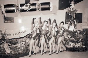 Pavillion showgirls by the Christmas tree