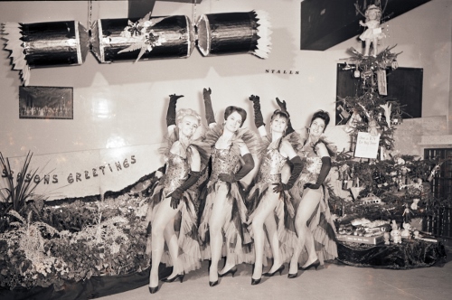 Pavillion showgirls by the Christmas tree