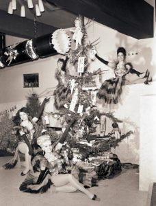 Pavillion showgirls by a giant Christmas cracker