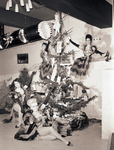 Pavillion showgirls by a giant Christmas cracker