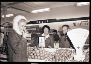 Lesley Langley bites into an apple at the M&S produce aisle