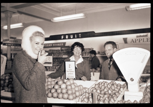 Lesley Langley bites into an apple at the M&S produce aisle