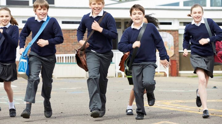 happy children are running across a playground.