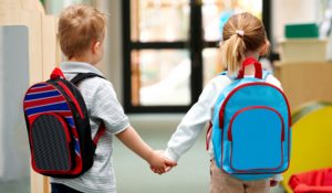 Two children walking hand in hand