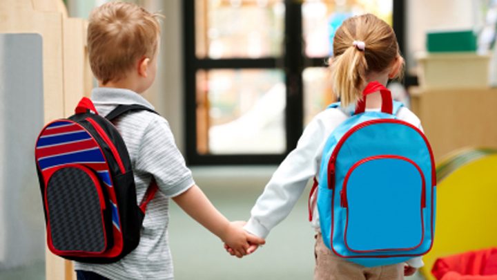 Two children walking hand in hand