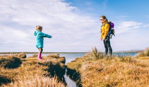 Mother and children walking by the sea