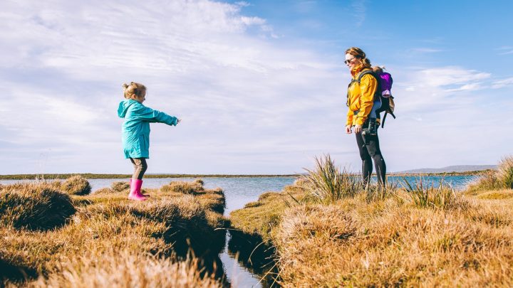 Mother and children walking by the sea