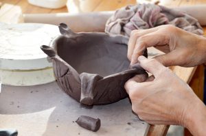 Hands working with clay