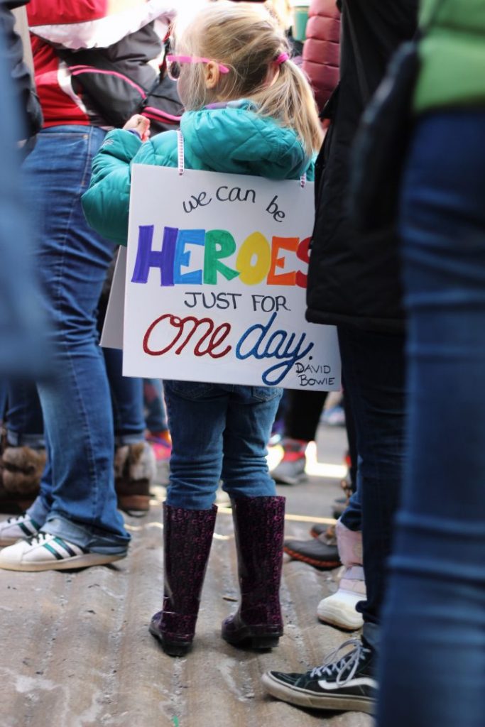 Little girl with hero sign