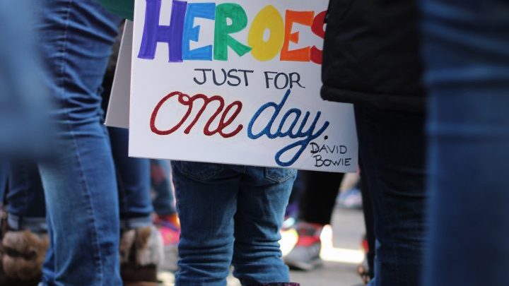 Little girl with hero sign