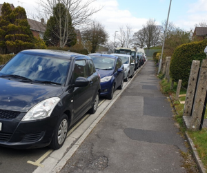 car parked along road on yellow lines