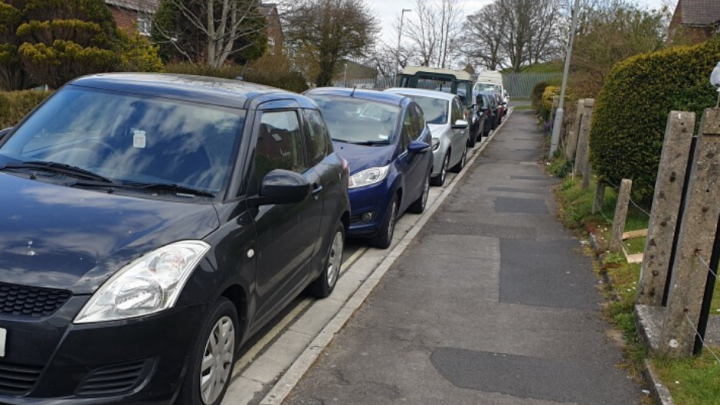 car parked along road on yellow lines