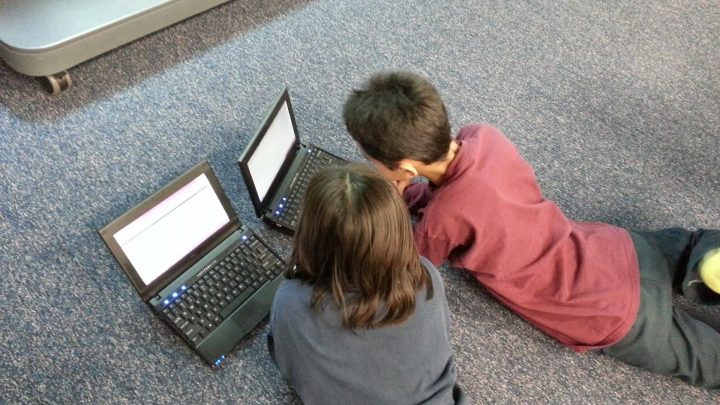 Children learning on laptop