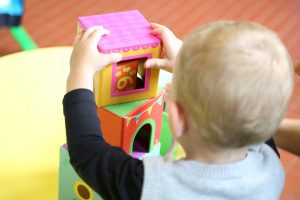Young child playing with toy