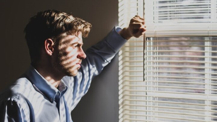 Man staring out window