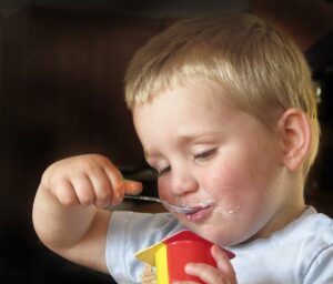 Boy eating a yoghurt
