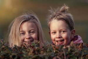 Children hid behind a bush