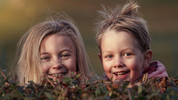 Children hid behind a bush