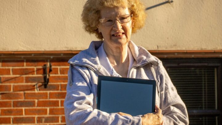Lady holding tablet (device)