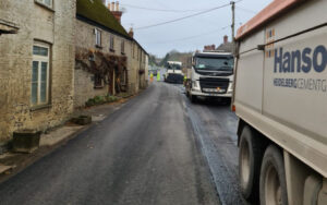 resurfacing trucks lined up on Dorset road