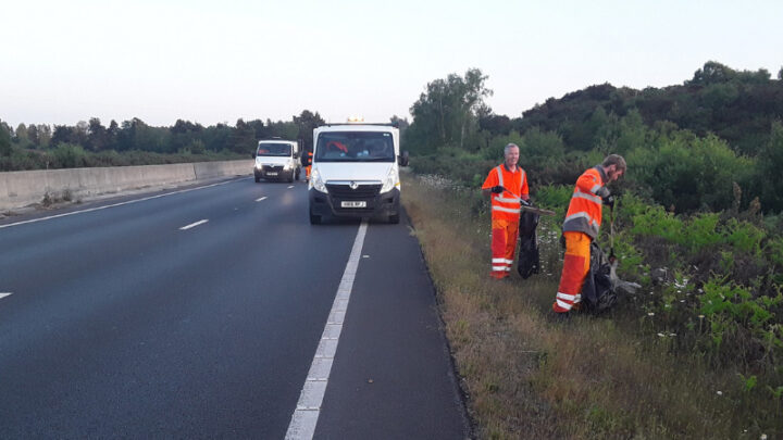 Two men litter picking on verges of A338 into Bournemouth