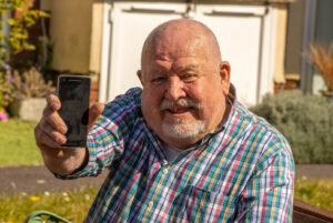 John Phillips, who is profoundly Deaf, was able to re-connect with people during lockdown thanks to a free smartphone from Dorset Council and Good Things Foundation charity.