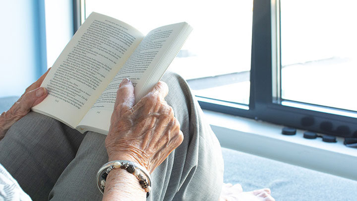 Woman reading book at home