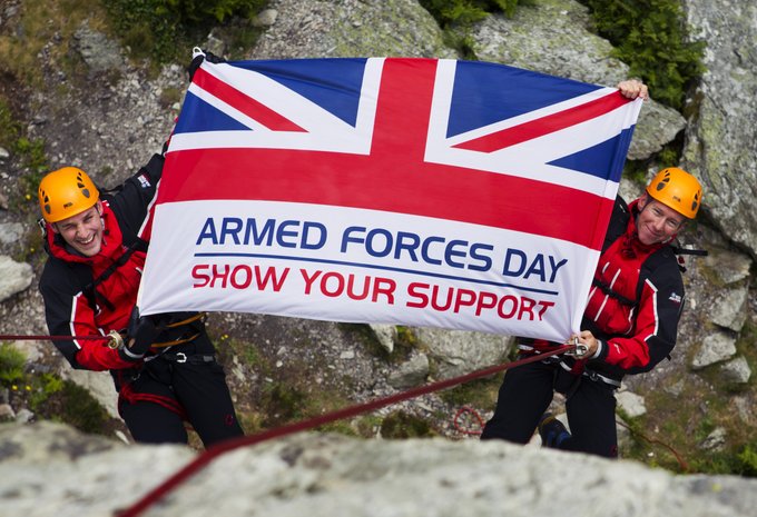 Armed Forces flag held by two people