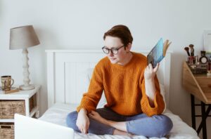 Young person sat on bed