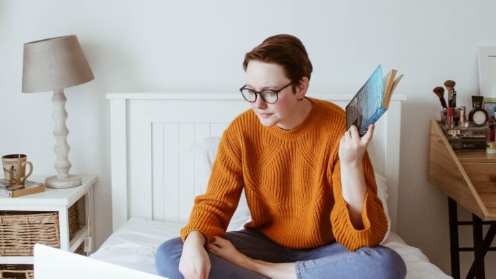 Young person sat on bed