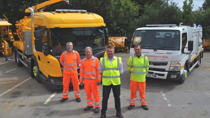 four workers stand in front of new gully cart and jetter