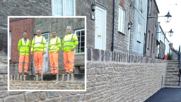 an image of the finished wall and the four workmen