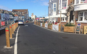 view down Custom House Quay of new temporary layout with wider footway and outside dining areas