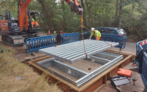cattle grid being lowered into place with frame already installed and visible