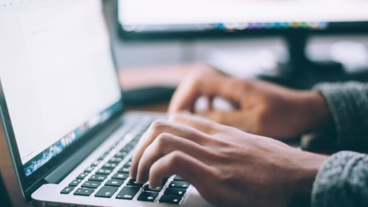 hands typing at a computer