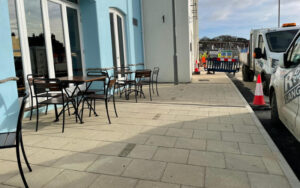 Section of completed paving wth works area in the distance