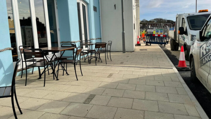 Section of completed paving wth works area in the distance