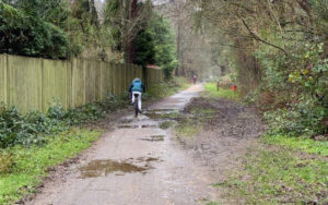 cyclists using very wet and muddy trailway before maintenance