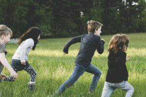 Children Running in a grass field