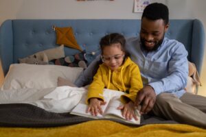 man and child reading book