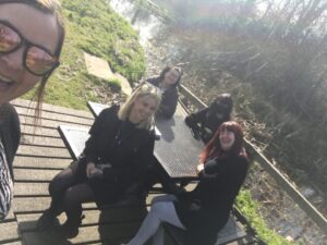 The youth voice team outside, smiling at the camera. 