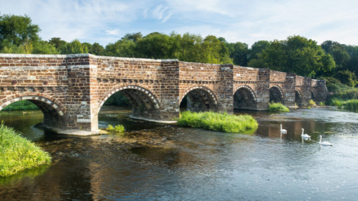 White Mill Bridge over river, swans swimming underneath