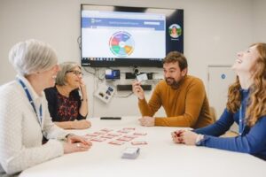 Four people talknig over a table.
