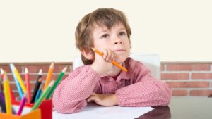 A boy is sat in a class room