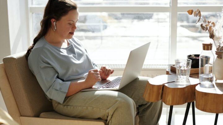 Girl with learning disability working on a laptop